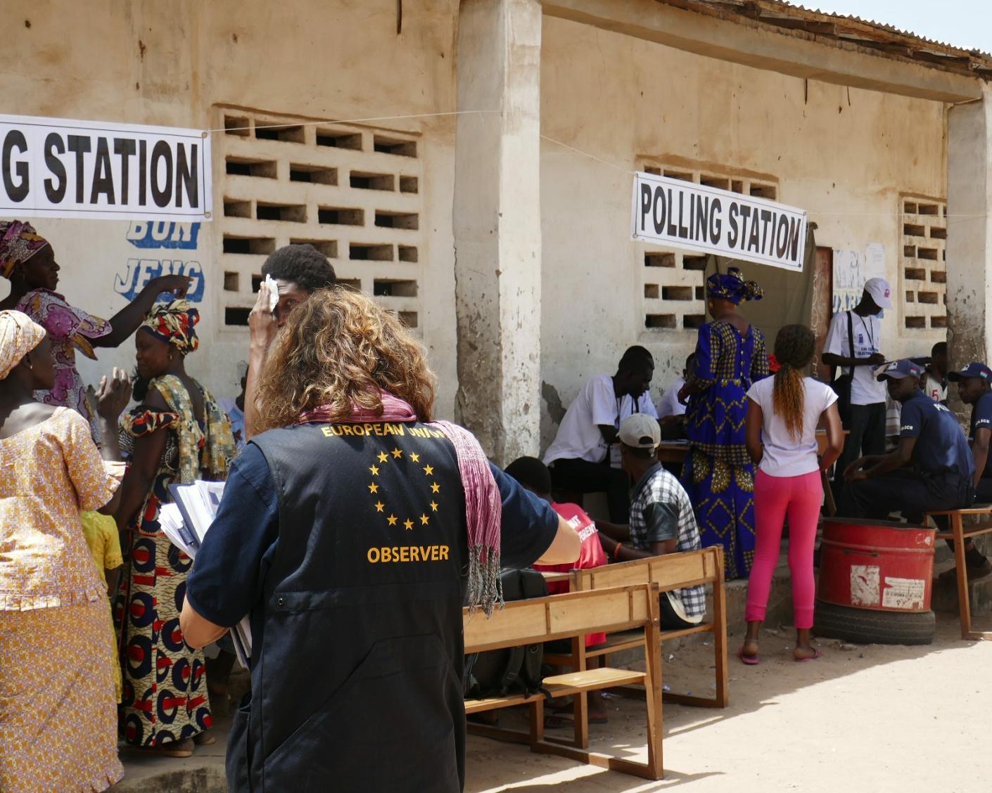 people queuing at a polling station