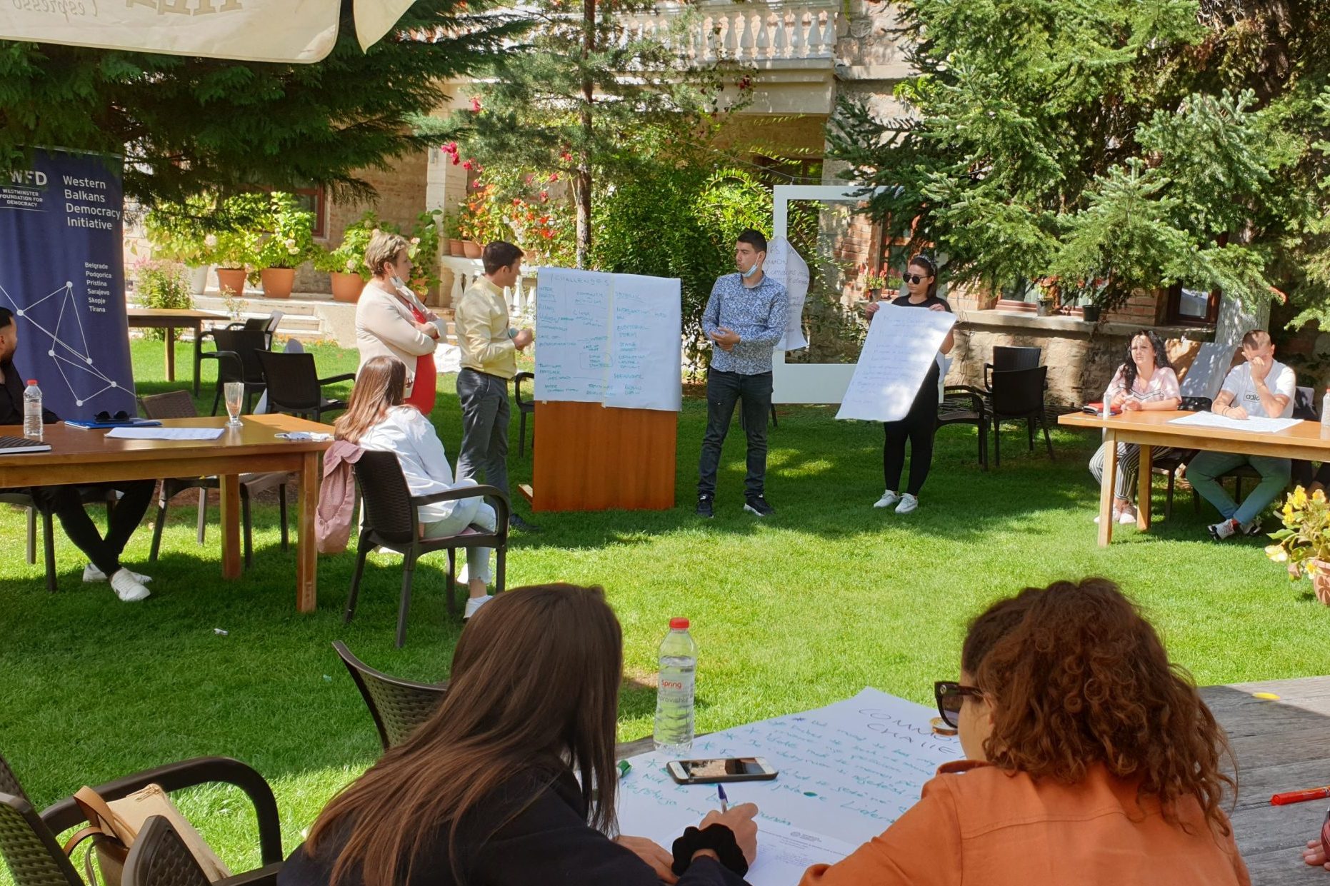 People looking at a flipchart during an outdoor workshop