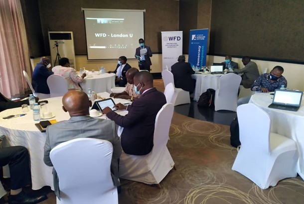 Stakeholders sitting round tables at a meeting