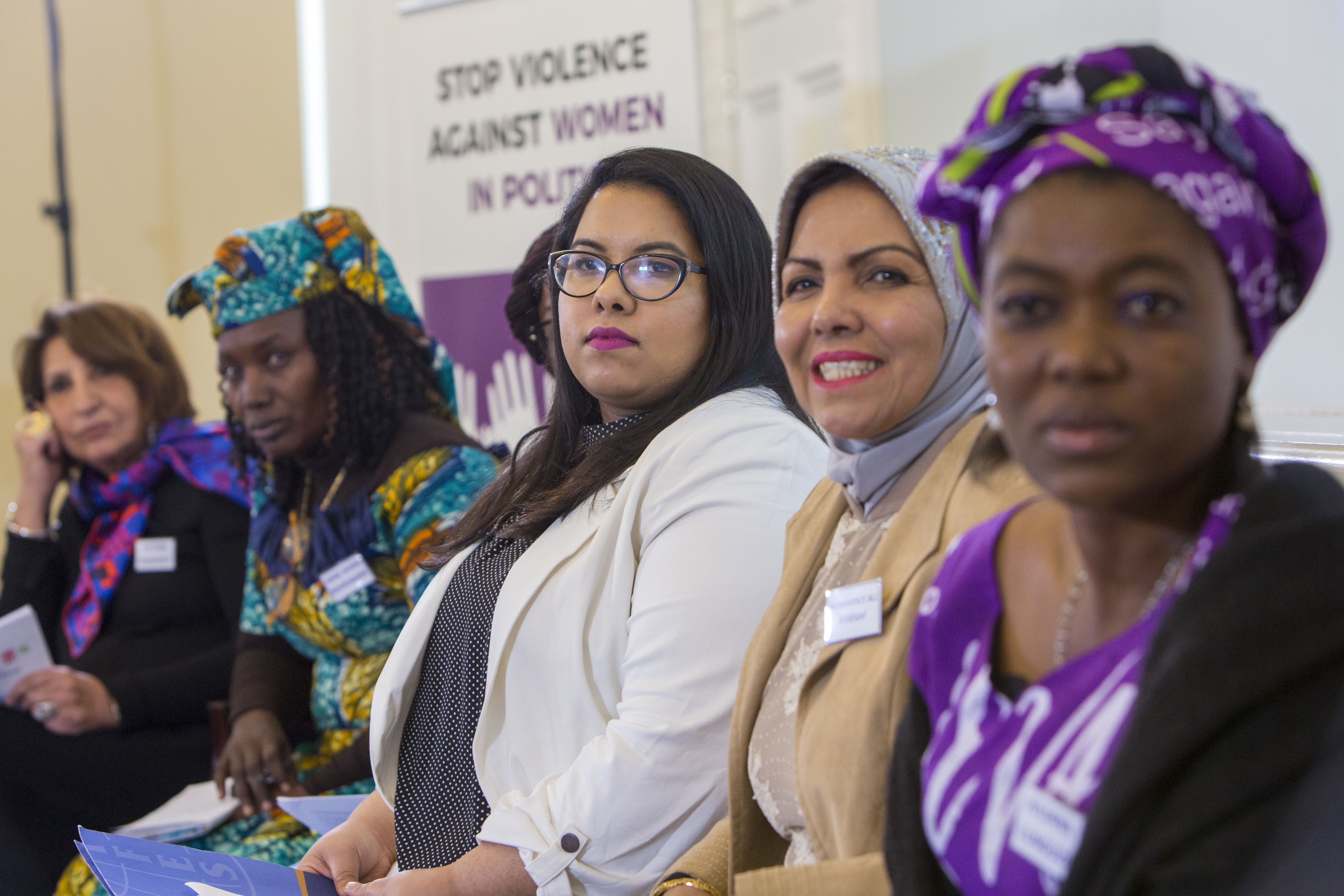 Women at a stop violence against women in politics event