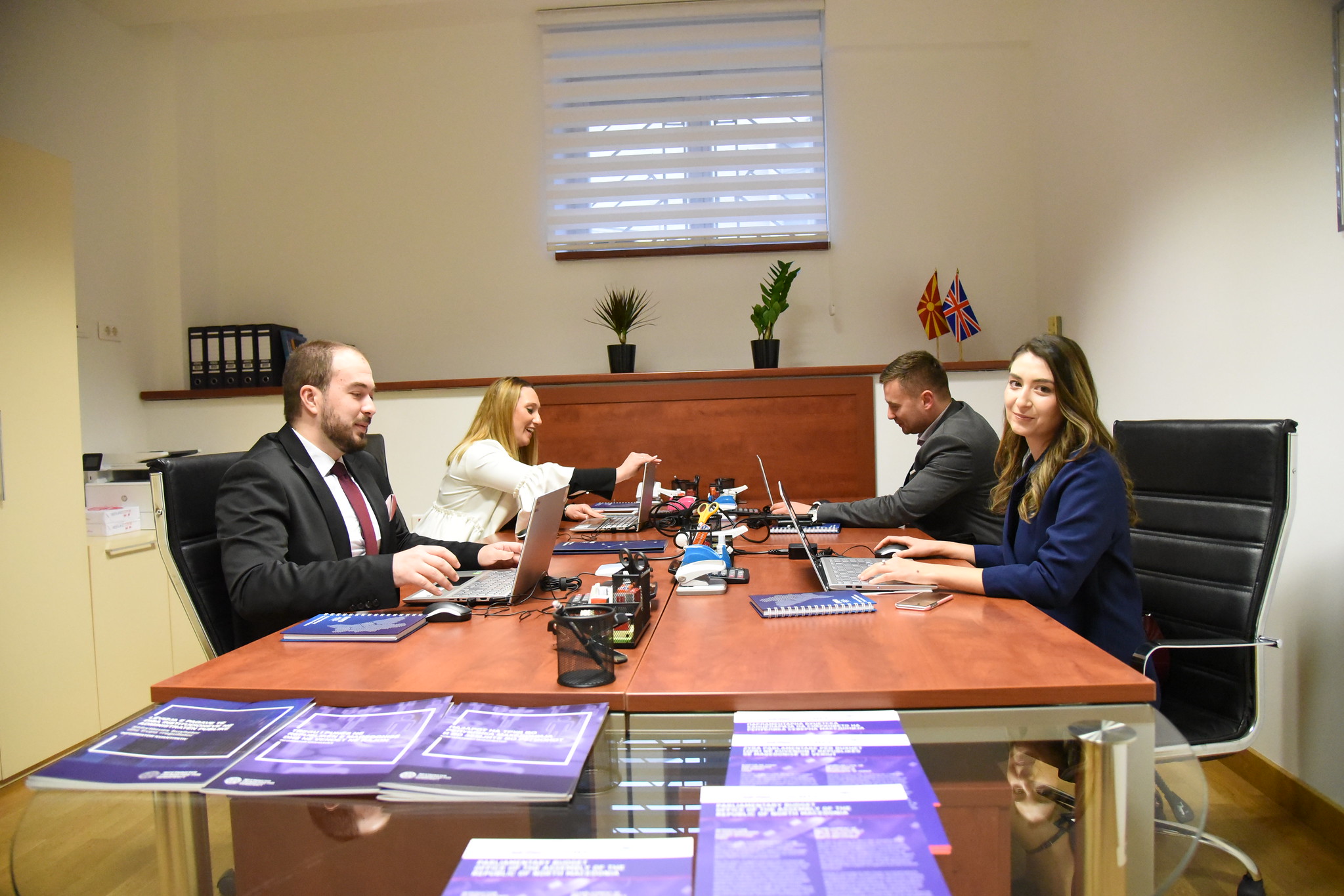 people working at a table in a parliamentary budget office