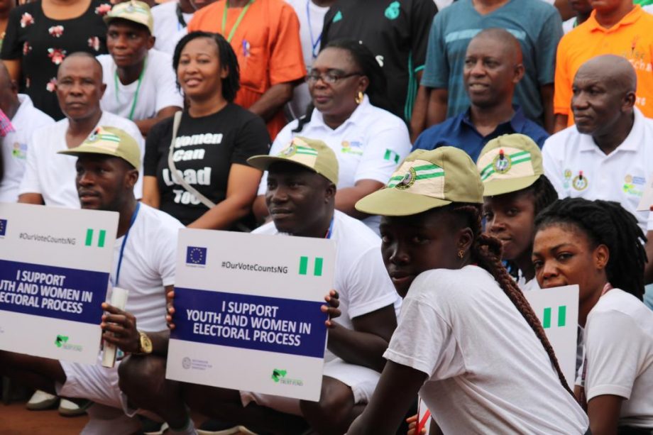 A group of people with some holding placards 