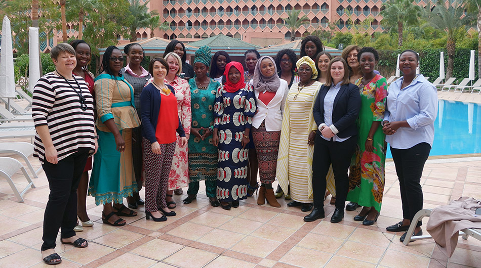 Women posing for a picture by standing