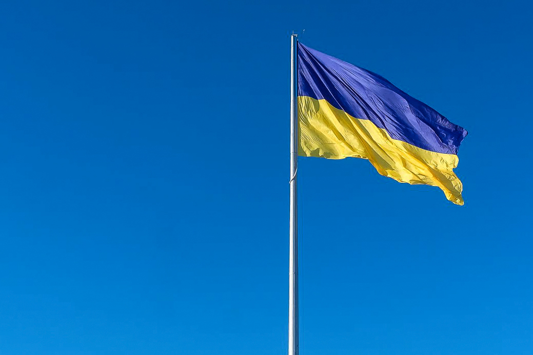 Flag of Ukraine flying against a clear blue sky