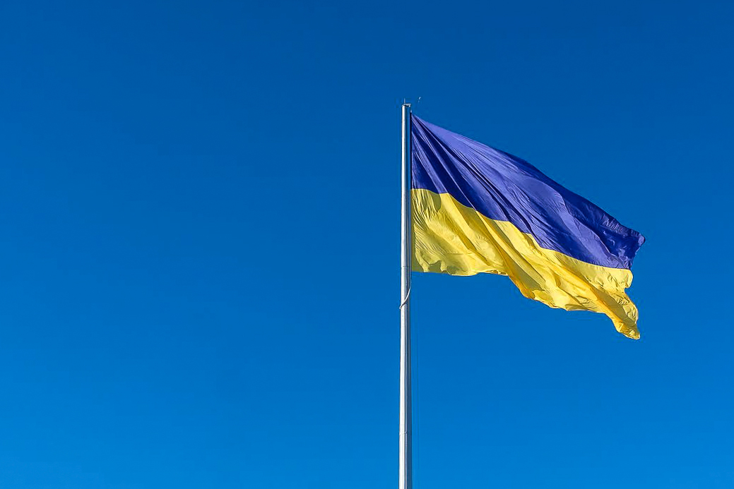Flag of Ukraine flying against a clear blue sky