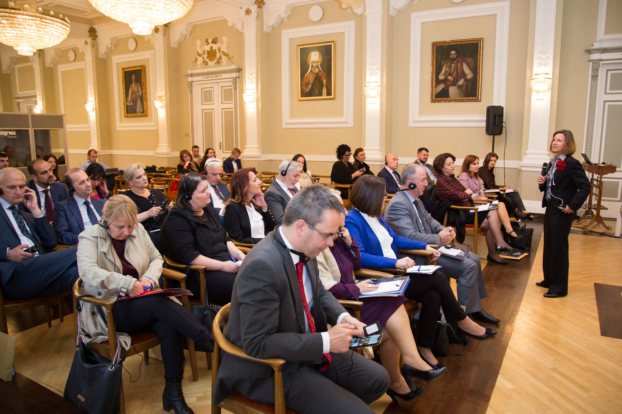 People listening to a WFD representative speak at a conference