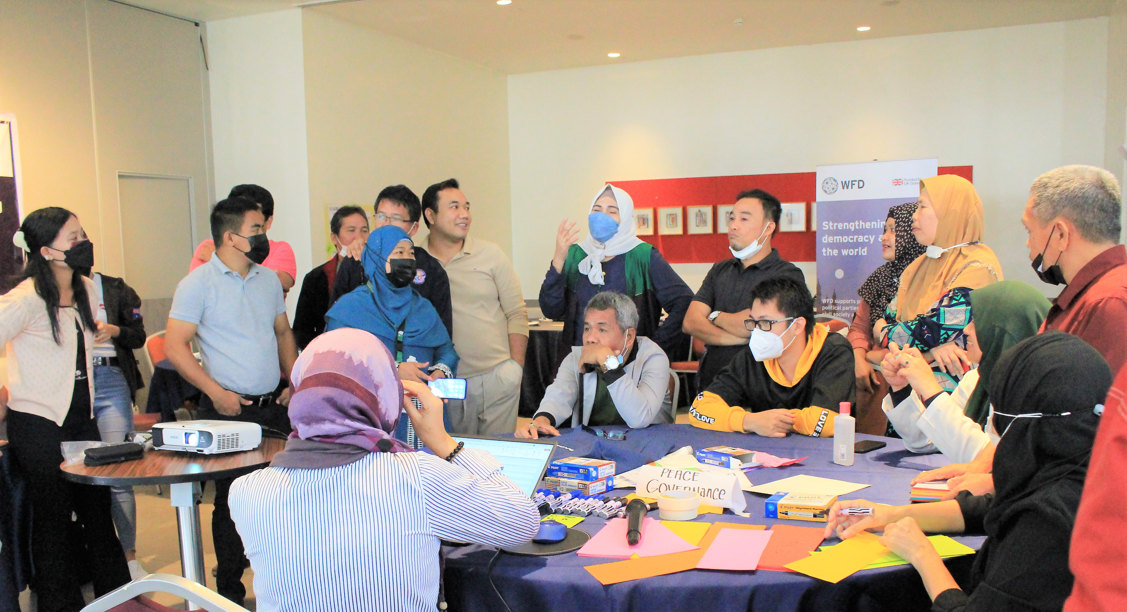 A group of CSO representatives gathered around a table at a training workshop