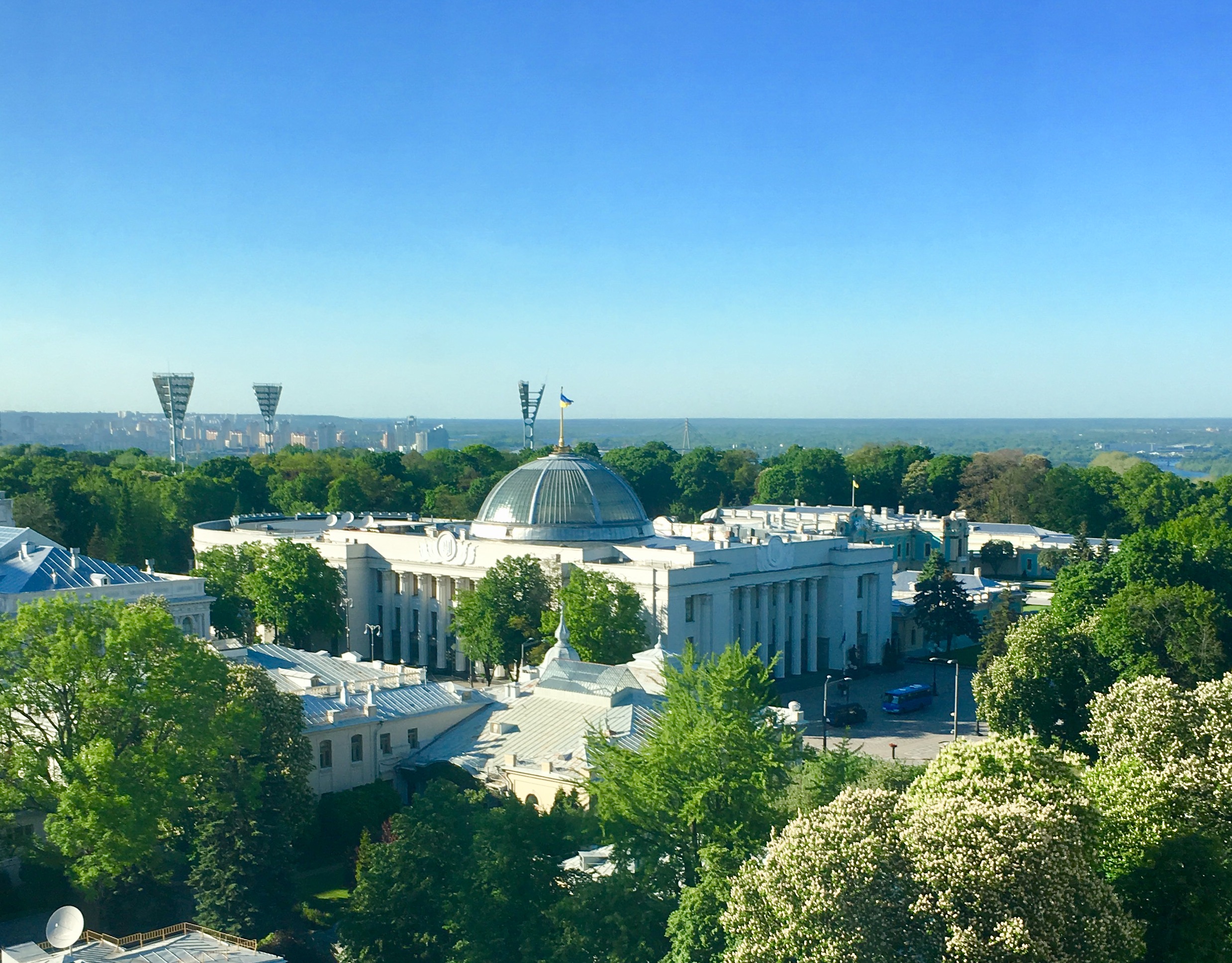 The Verkhovna Rada of Ukraine with the Ukrainian flag flying above the dome on a sunny day