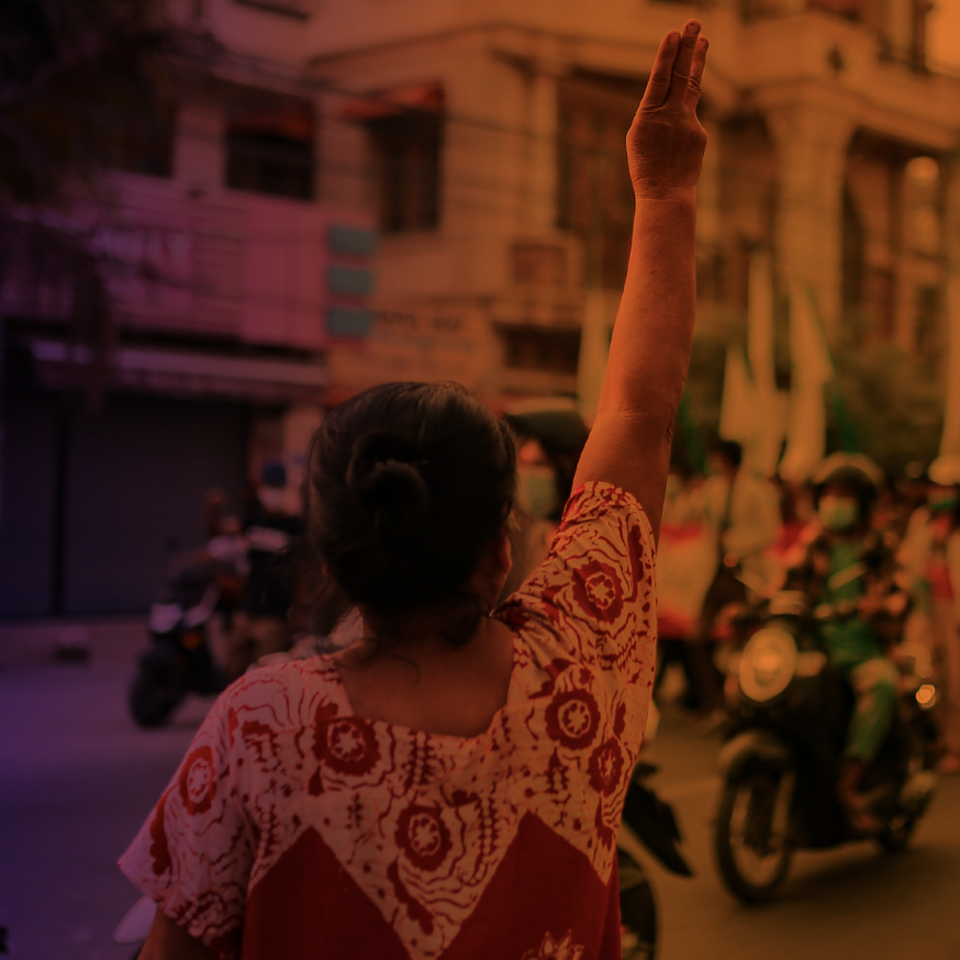 A protestor in Myanmar raises  a three finger salute in protest