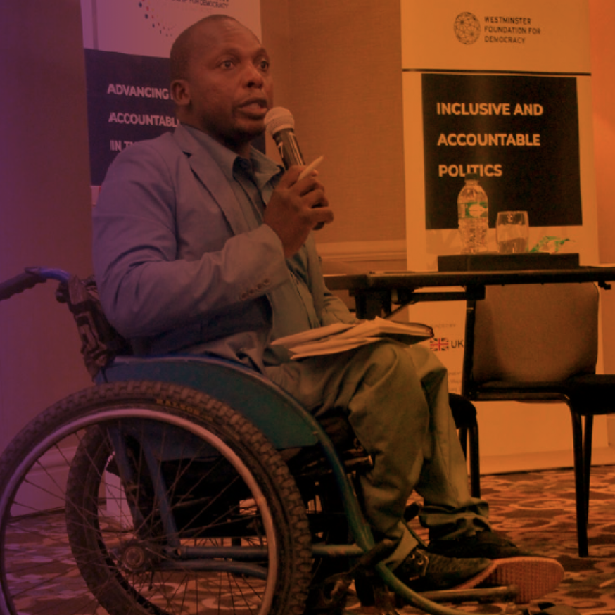 A speaker at a WFD launch event, sitting a wheelchair