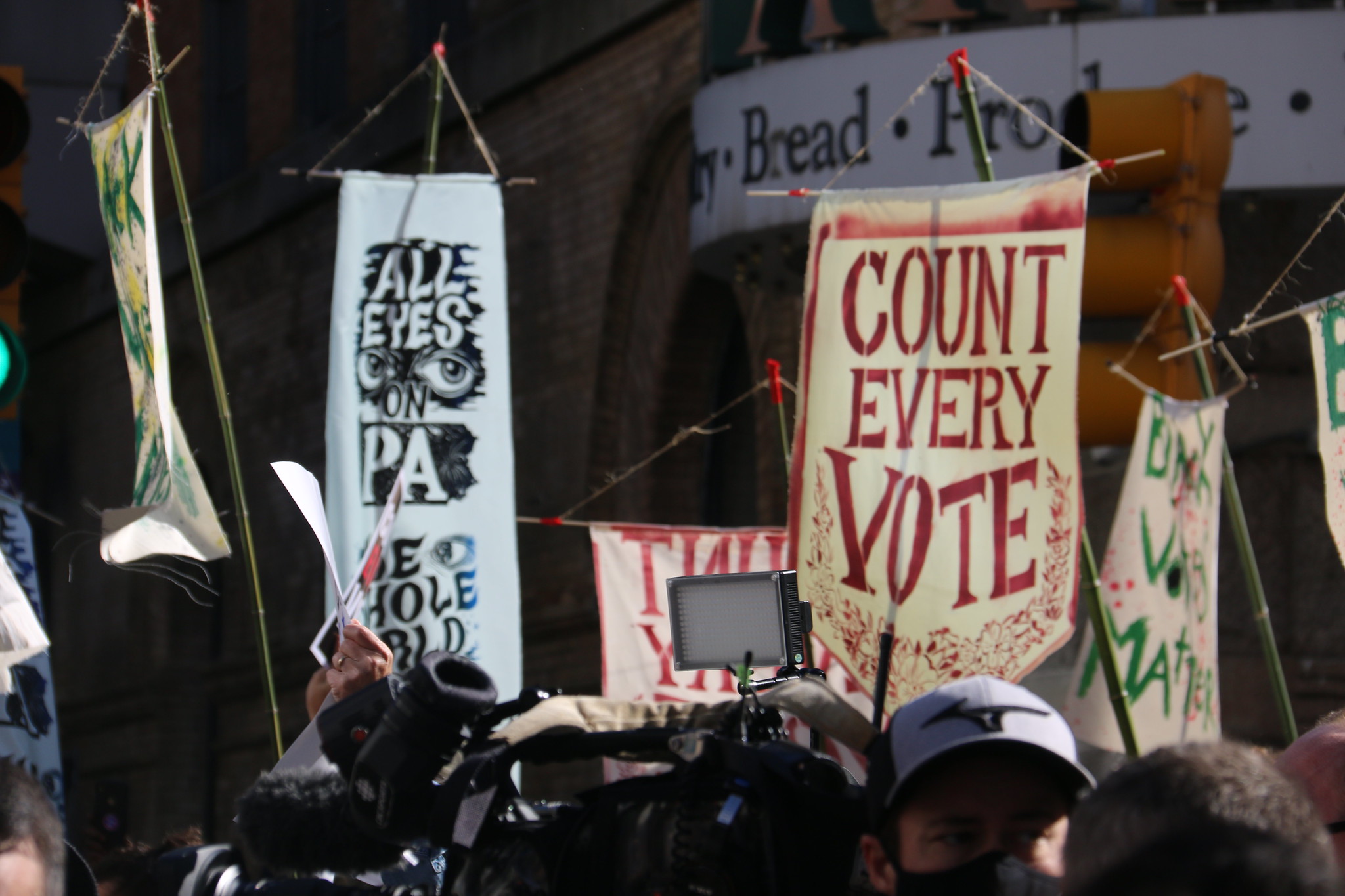 Banners held outside a counting centre during US elections saying 'count every vote'