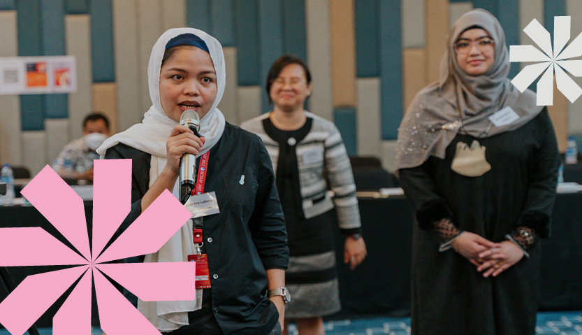 Woman speaking through a microphone