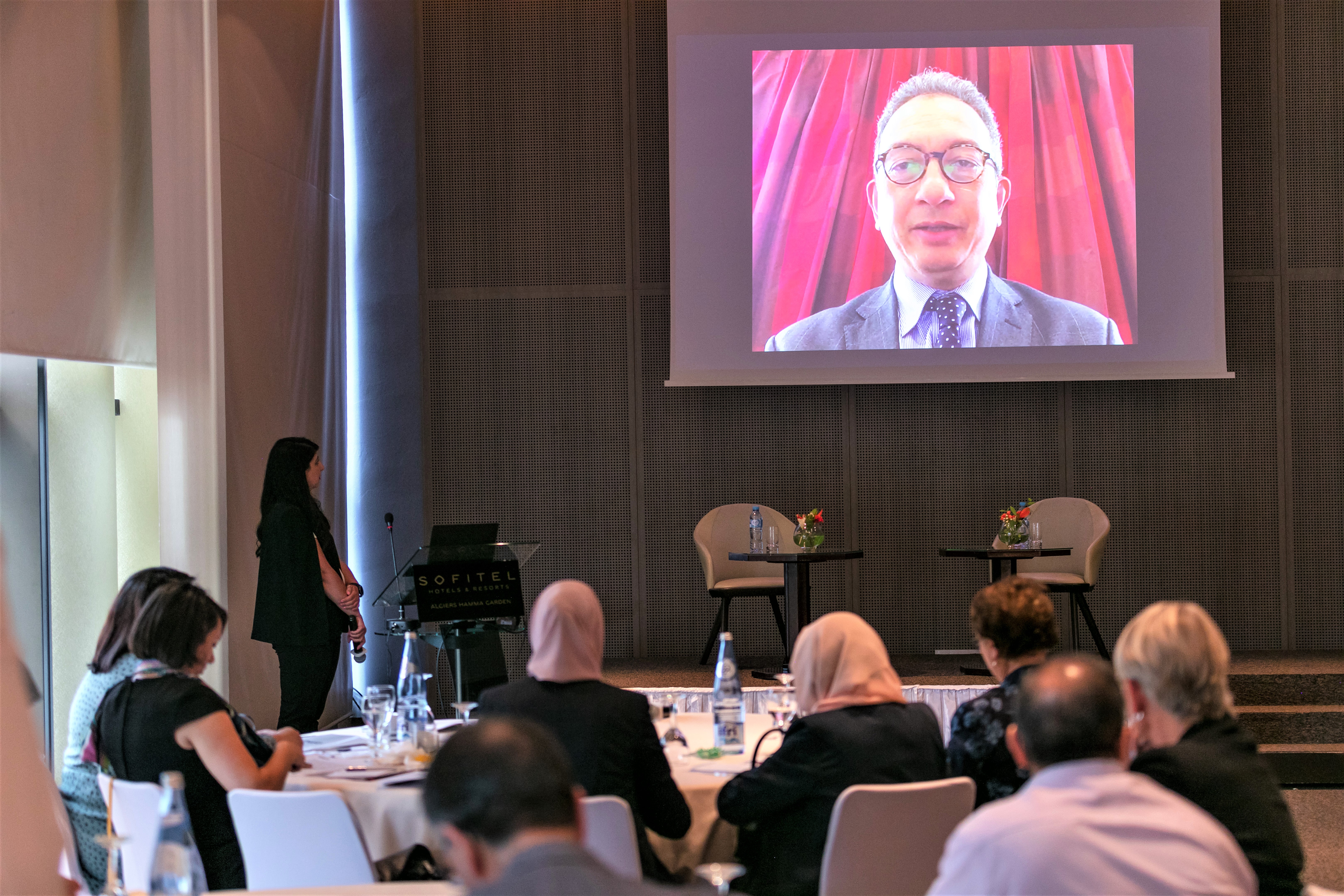 A person virtually addressing others in a room