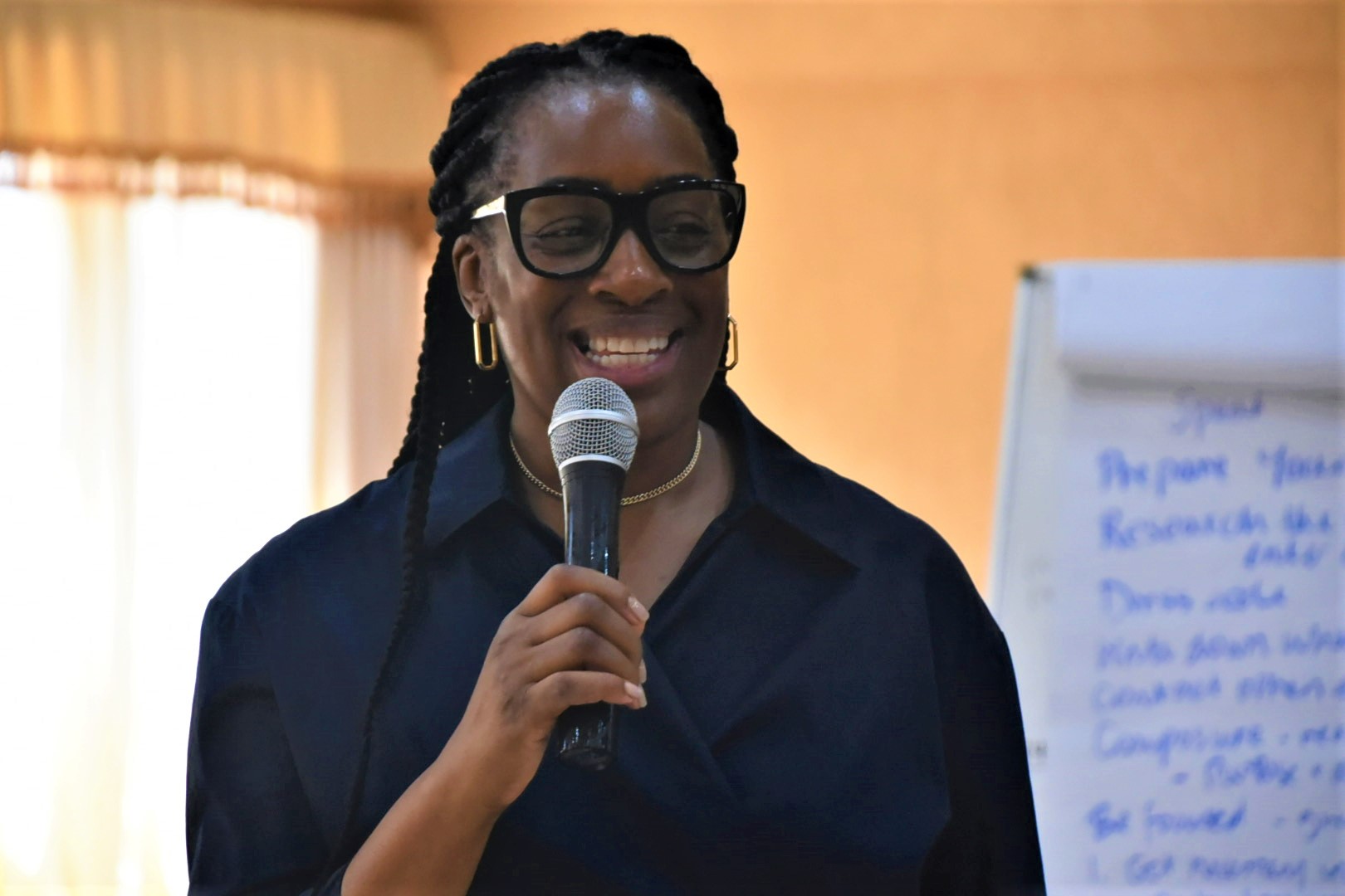 A woman speaking using a microphone