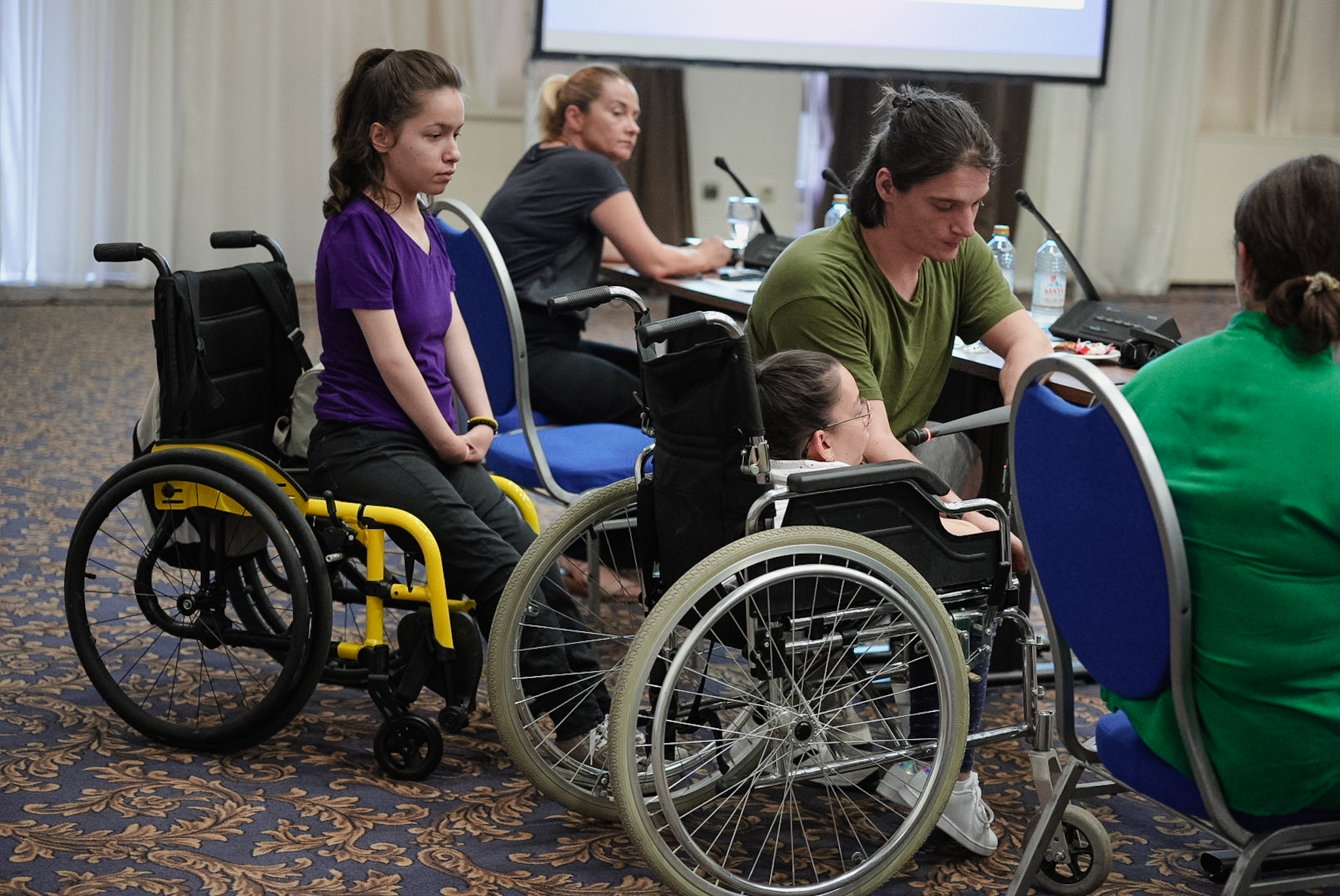 A group of people sitting on a wheelchair