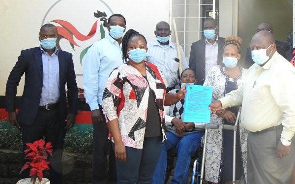 Group of people holding an MoU document