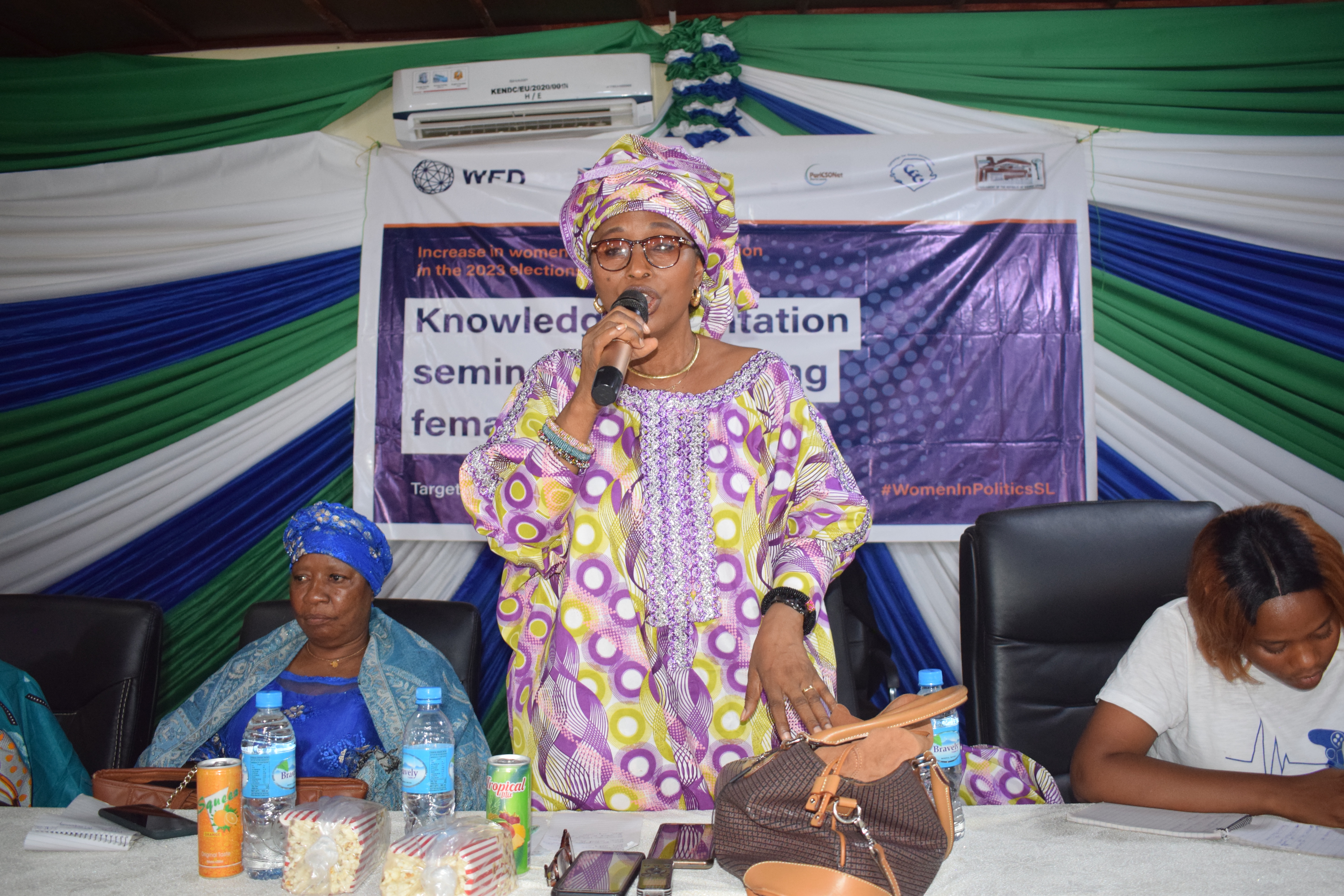 A woman speaking using a microphone