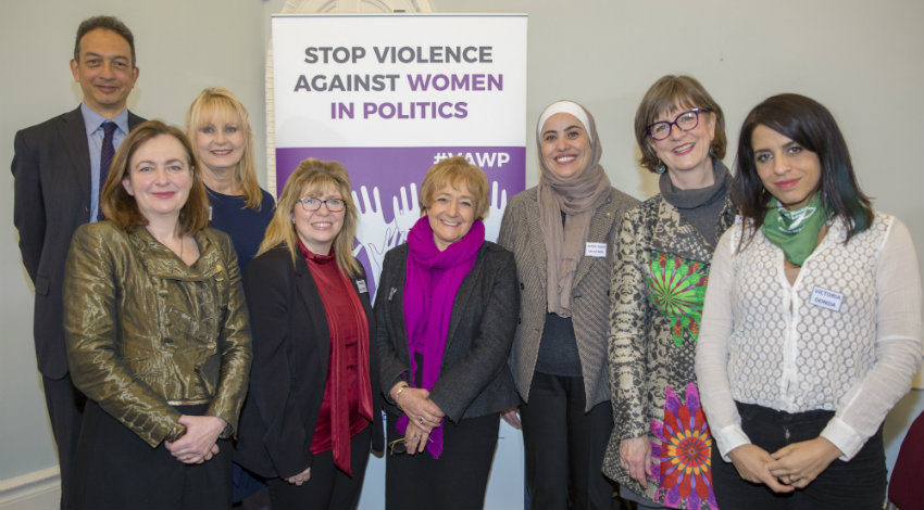 Group of women and one man posing