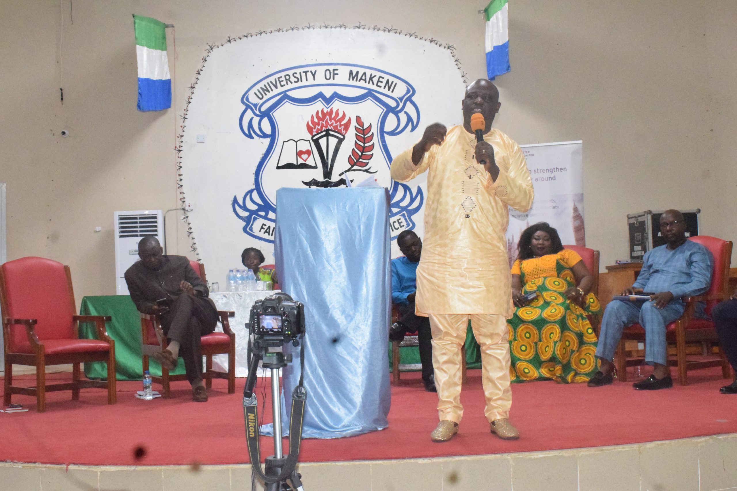 A man addressing others in a townhall meeting