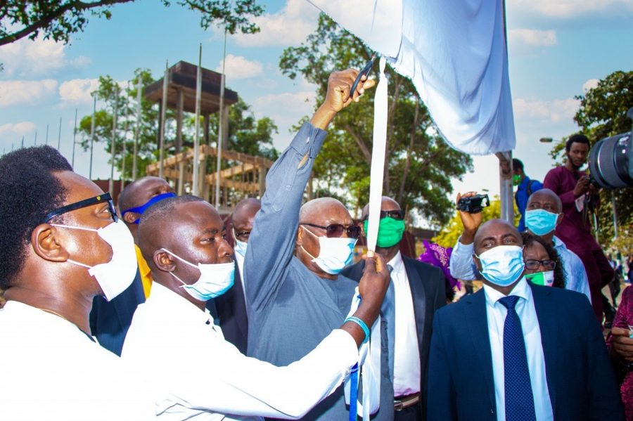 People cutting a ribbon to unveil a service charter