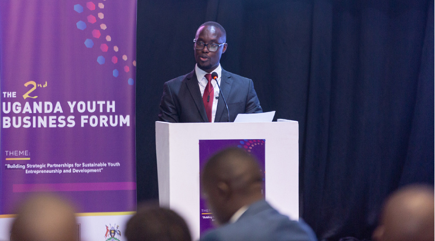 A man addressing others in a conference