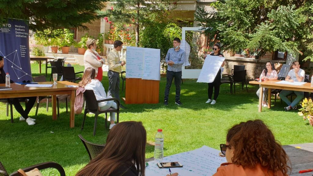 People looking at a flipchart during an outdoor workshop