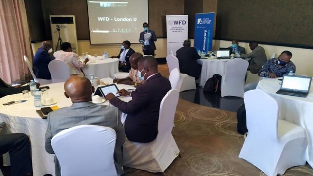 Stakeholders sitting round tables at a meeting