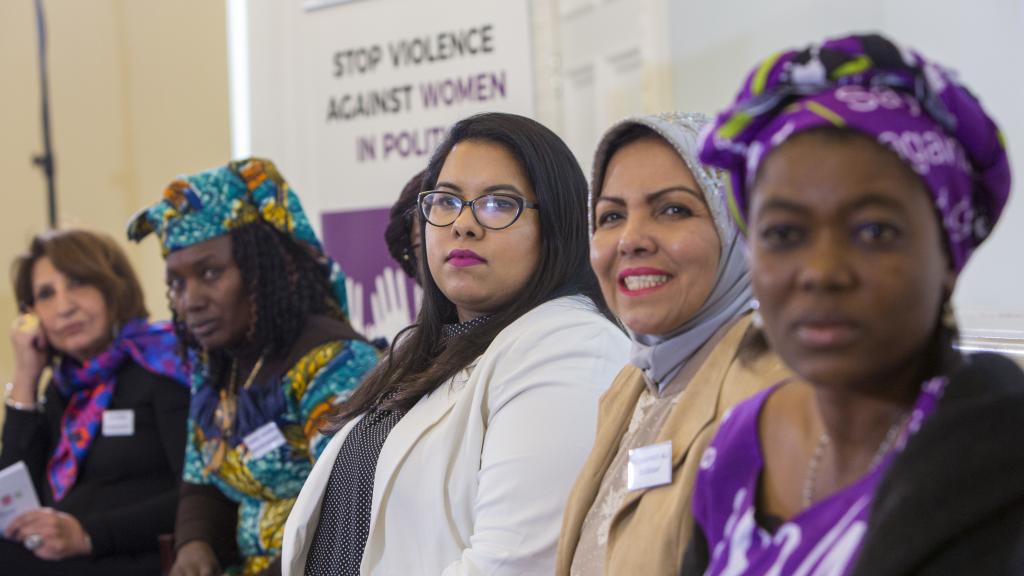 Women at a stop violence against women in politics event
