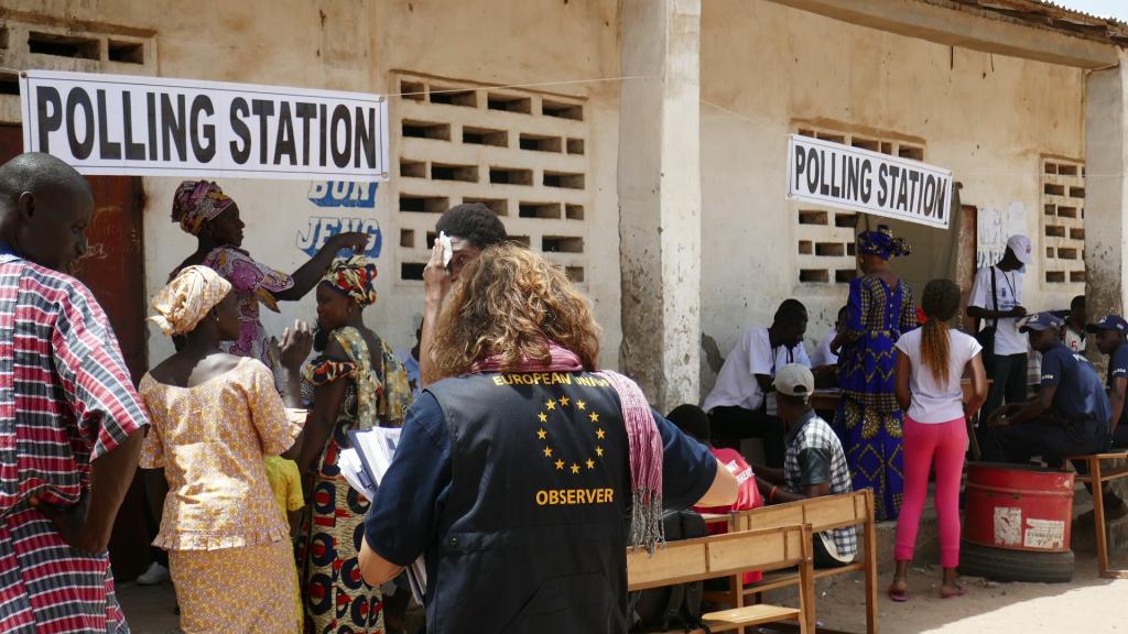 people queuing at a polling station