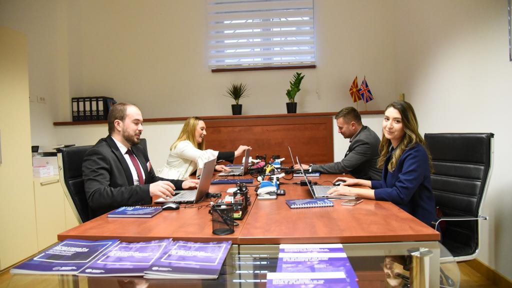 people working at a table in a parliamentary budget office