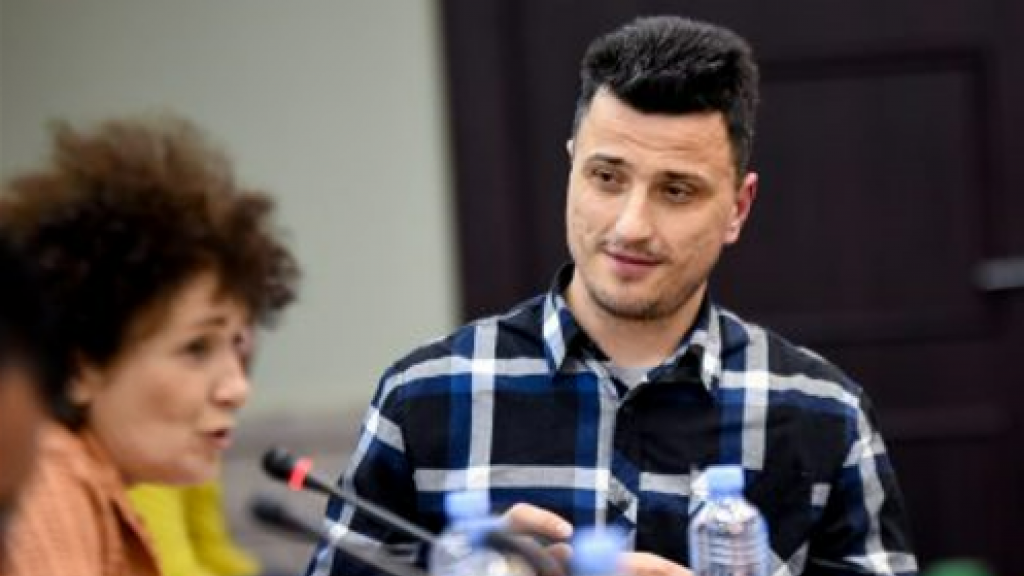 man looking at a woman speaking