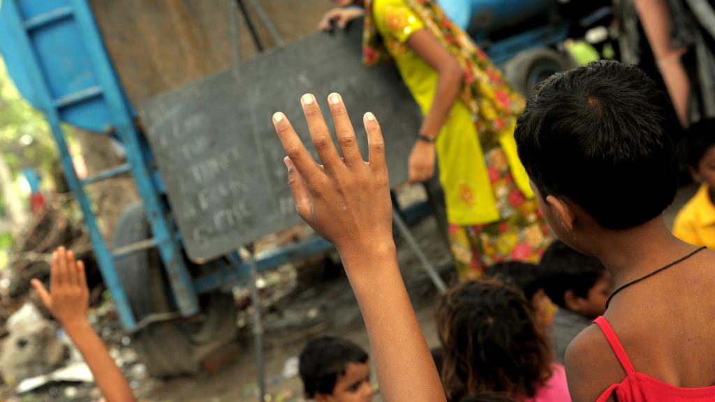 a hand raised in a school classroom in India