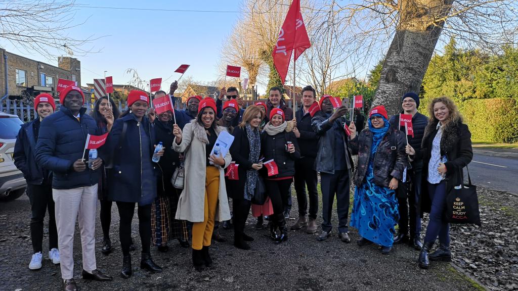 A group of people waving labour flags