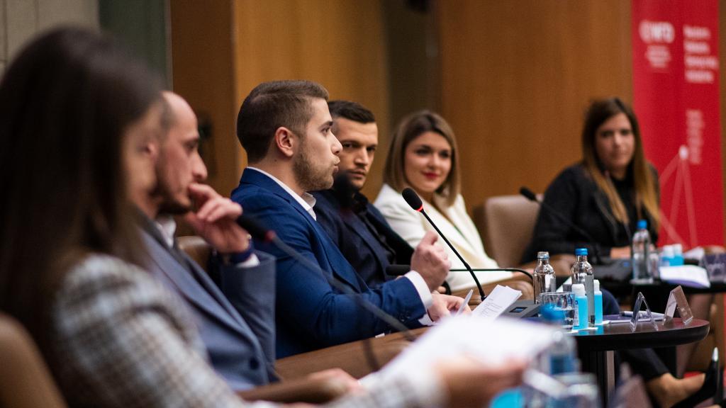 Young man speaking at a conference