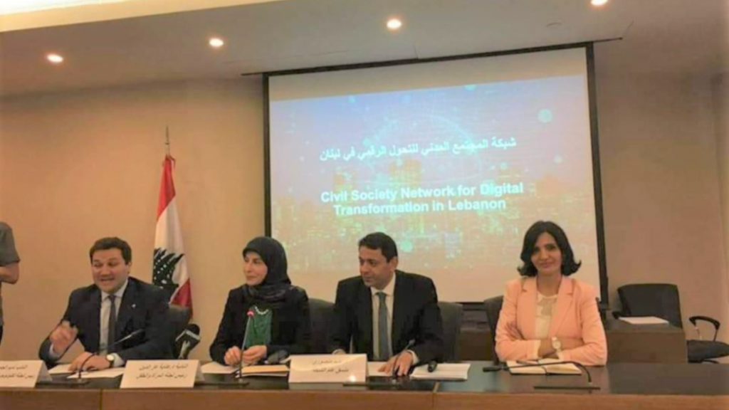 Four people sitting at a table presenting
