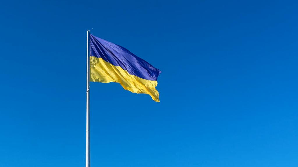 Flag of Ukraine flying against a clear blue sky