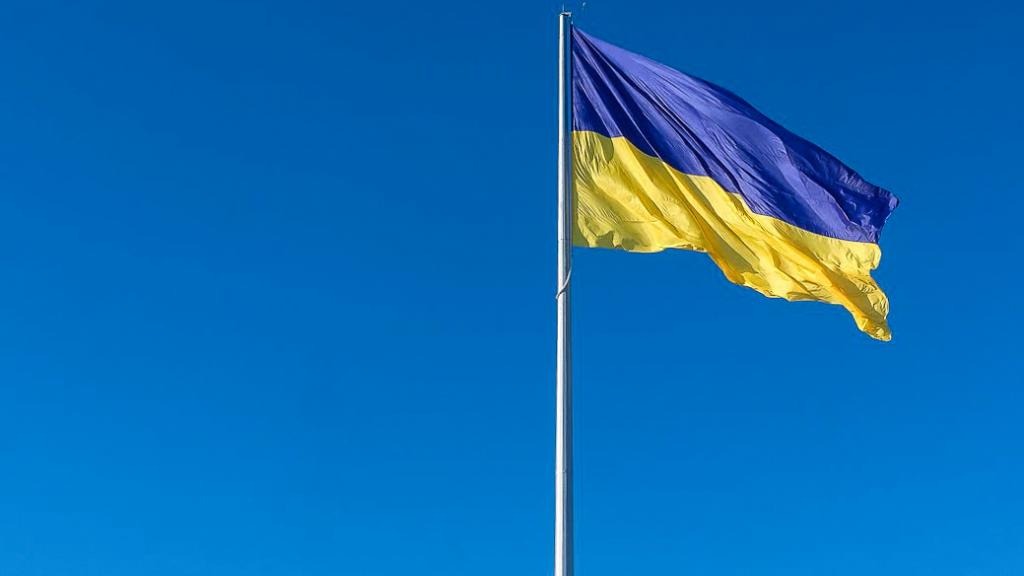 Flag of Ukraine flying against a clear blue sky