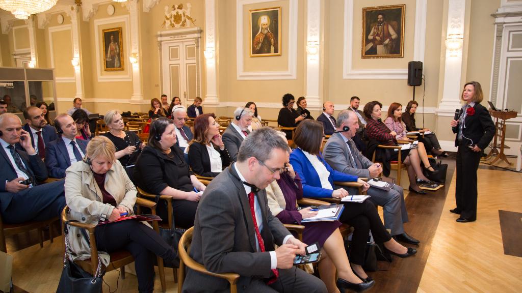 People listening to a WFD representative speak at a conference