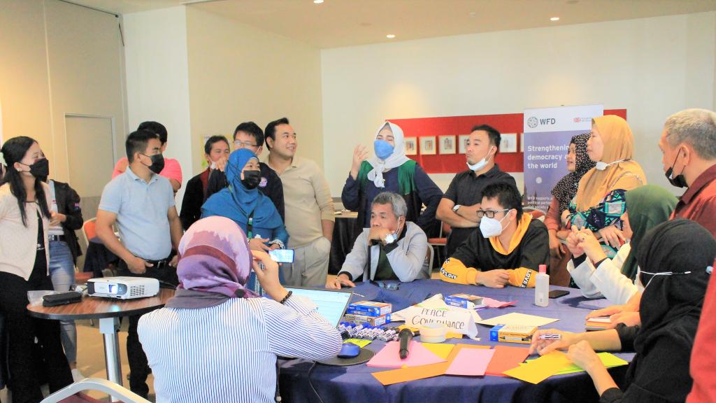 A group of CSO representatives gathered around a table at a training workshop