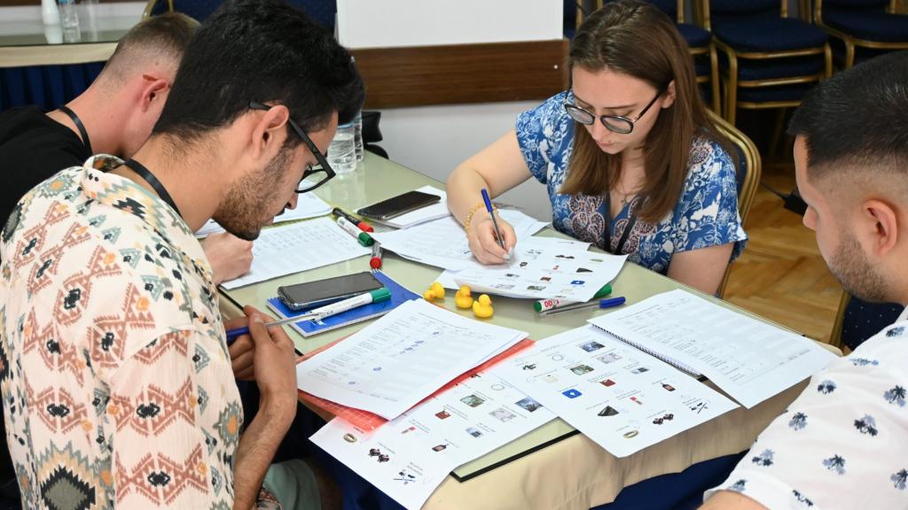 young people sitting at a table working