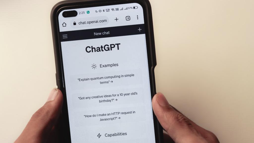 Hands holding a mobile phone with ChatGPT on screen