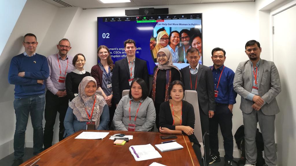 a group of men and women smiling at the camera