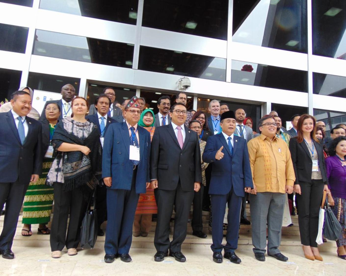Group of smartly dressed people standing outside building