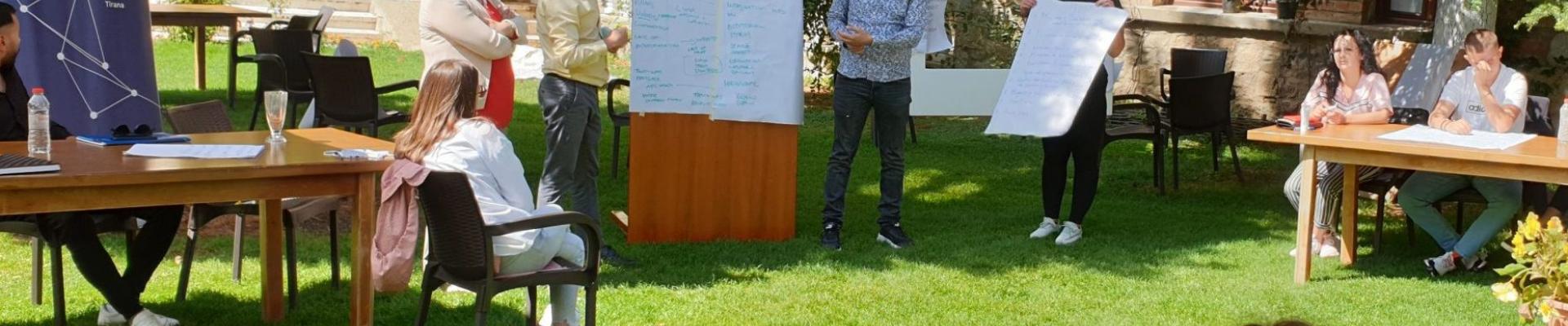 People looking at a flipchart during an outdoor workshop