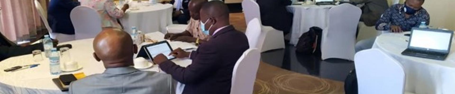 Stakeholders sitting round tables at a meeting