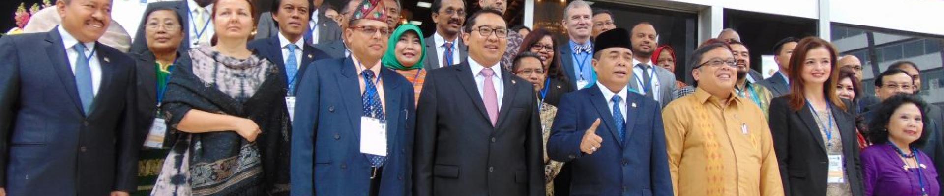 Group of smartly dressed people standing outside building