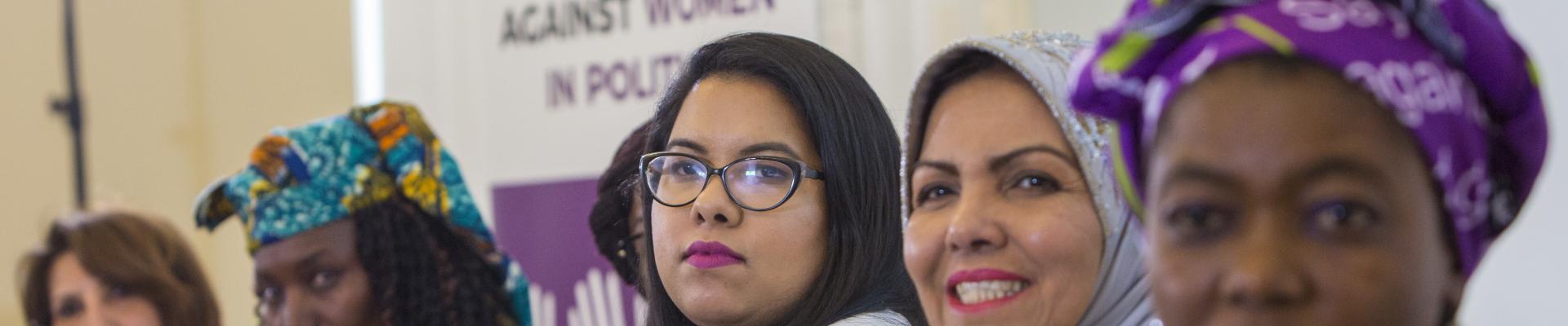 Women at a stop violence against women in politics event