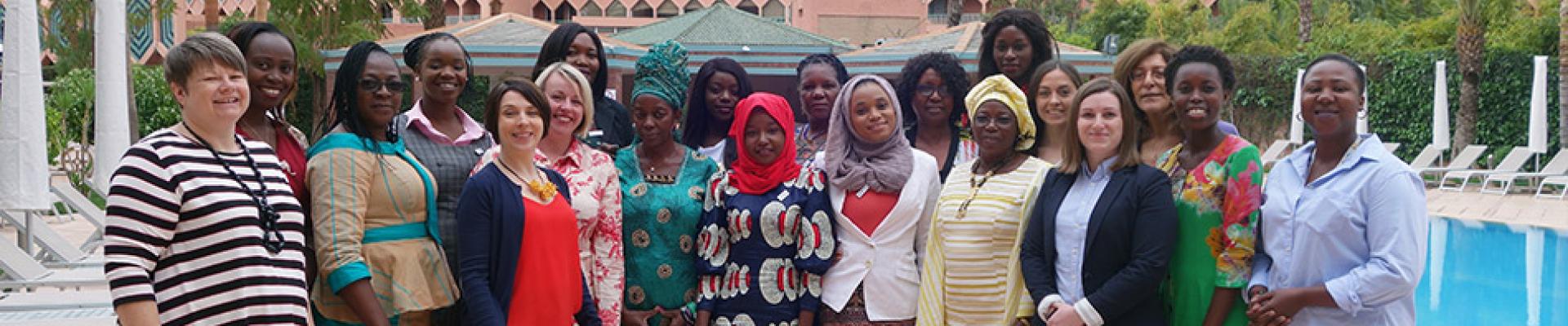 Women posing for a picture by standing