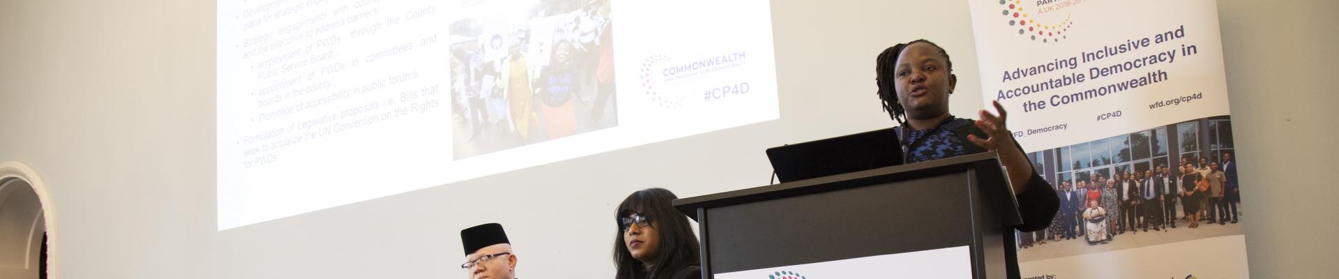 A person speaking at a podium at a CP4D conference