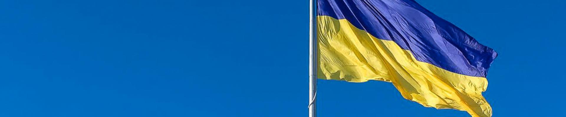 Flag of Ukraine flying against a clear blue sky
